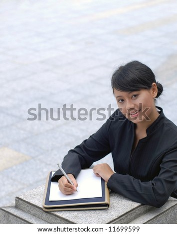 Smiling and cheerful of young business woman signing the document.
