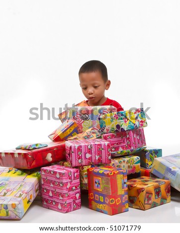 Little boy getting surprises with gift boxes