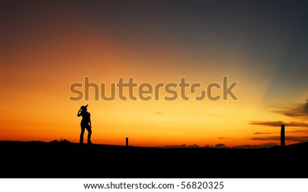 Silhouette model poses during sunset