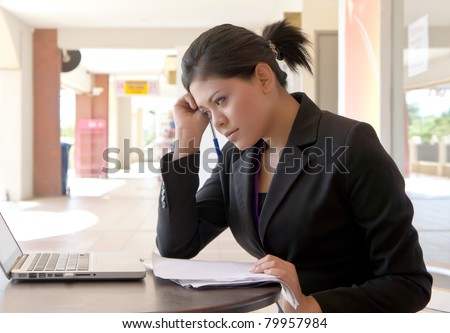 Young Asian businesswoman working under pressure at outside office.