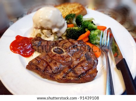Fire grilled lamb served with mashed potatoes and veggies