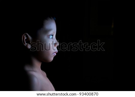 Boy watching static on television in the dark