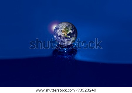 Earth globe floats on crystal clear water ripples. Earth Map courtesy of NASA