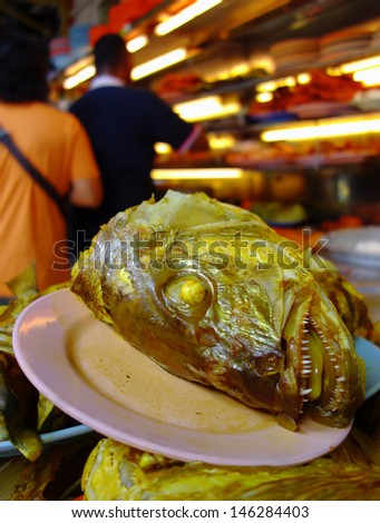PENANG, MALAYSIA-JULY 6: A famous Fish Head Curry dishes of \'nasi kandar\' or \'kandar rice\' in Penang, Malaysia on July 6, 2013. Nasi kandar is a popular spicy dish from Penang Indian Muslim.