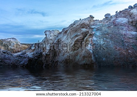 stone rock fills with water. digital compositing, colour tone, water reflection and ripple effects.