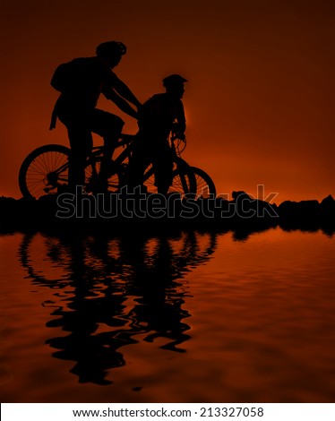 Silhouette of tourists with bicycle during sunset. digital compositing, colour tone, water reflection and ripple effects.