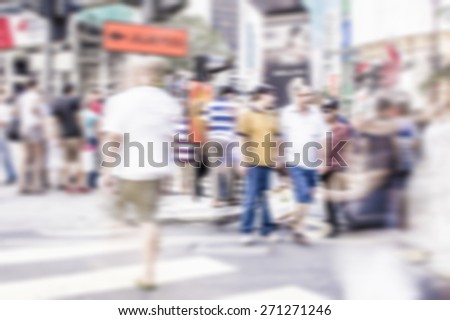 Busy people on street in defocused blur concept with vintage  color style and effects.