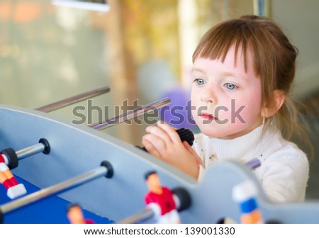 Little girl playing board football