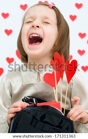 Valentine\'s Day - dreaming cute child holding red hearts