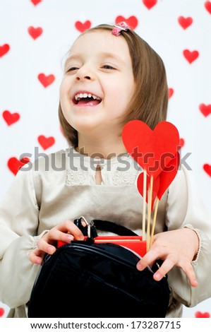 Valentine\'s Day - dreaming cute child holding red hearts