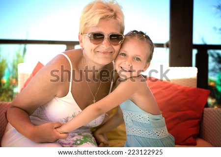 grandmother and her cute little granddaughter giving each other a loving
