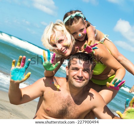Family concept. Happy family of three having fun at the beach