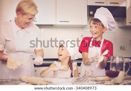 Grandmother with grandchildren baking cookies prepare dough