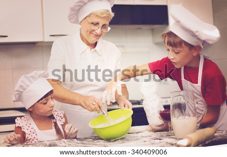 Grandmother with grandchildren baking cookies prepare dough