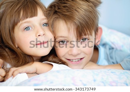 cute kids, brother with sister, waking up in bed at home