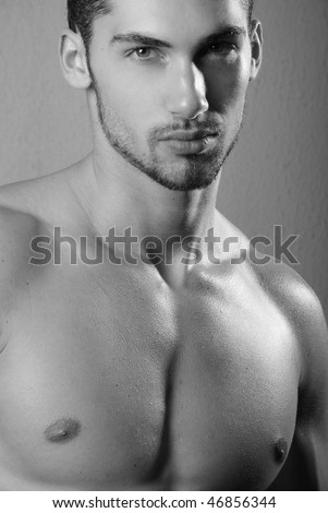 Young muscled male model posing in studio