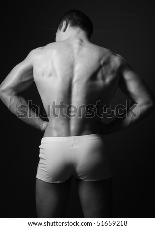 Muscled male model posing in studio