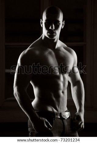 Muscled male model posing in studio