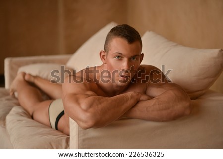 Muscled male model on white background