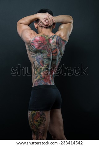 Male model with a snake and skull tattoo
