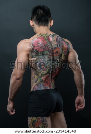 Male model with a snake and skull tattoo