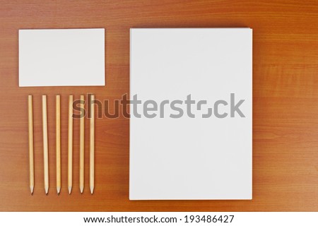 Corporate ID set on wood background for presentations and portfolios.