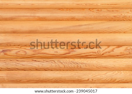 Natural background from log wall. Texture of wooden logs.