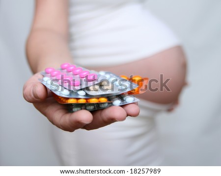 Pregnant woman holding medicine. Nine month. Third trimester