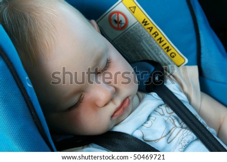 9 months old baby boy sleeping in car seat