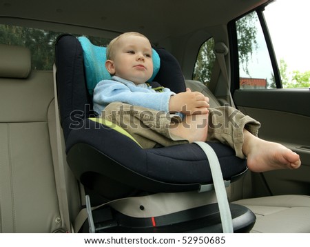 18 months old baby boy in car safety seat.