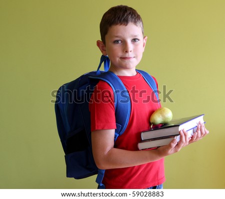 Boy ready for school with books and school backpack.