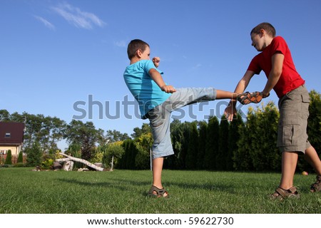 Sibling, two boys, friends boxing. Six and eight old boys  fighting.