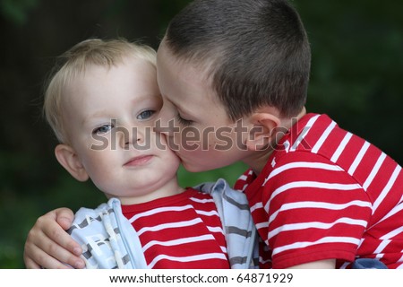 Portrait of two boys, siblings, brothers and best friends Ã¢Â?Â? 18 month old baby boy and 6 years old child.