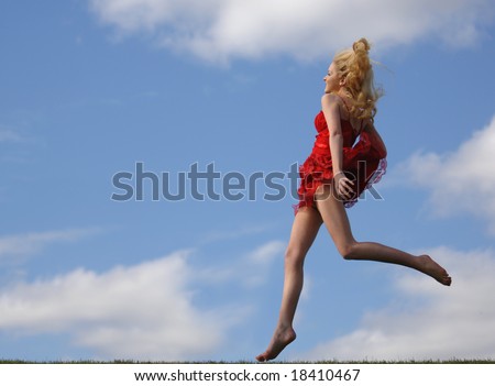 Portrait of a beautiful young fashion model Jumping for Joy