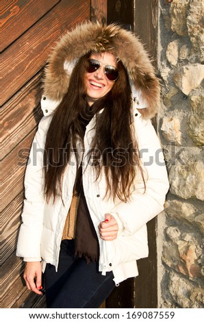 Beautiful young woman enjoy life in winter wearing jacket with fur