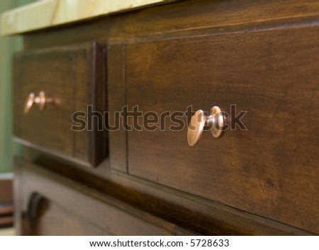 Bathroom drawers with antique copper knobs