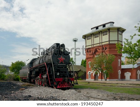 Moscow, Russia - May 17 2014: LV-0283 steam locomotive and water tower (1901, Art Nouveau) on old railway station Podmoskovnaya.