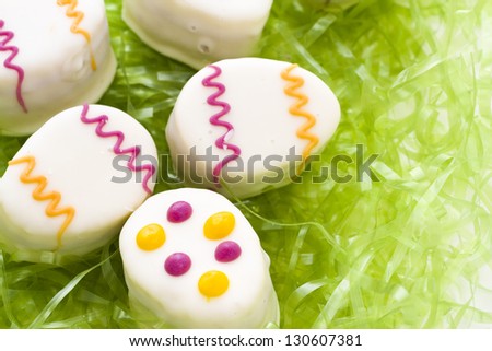 Easter egg petit cakes made with layers of vanilla cake and tart, raspberry jam.