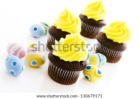 Gourmet cupcakes with yellow icing prepared for Easter.