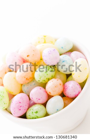 Assorted jelly beans in pastel colors with darker spots.
