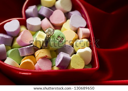 Canversation Heart candies in heart shaped container.