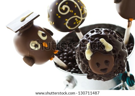 Gourmet chocolate cake pops decorated for graduation party.