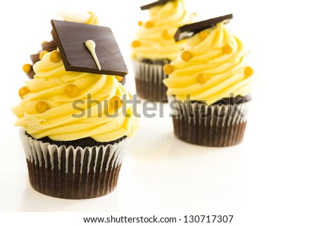 Gourmet chocolate cupcakes decorated for graduation party.