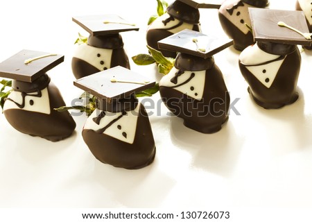 Gourmet chocolate covered strawberries decorated for graduation party.