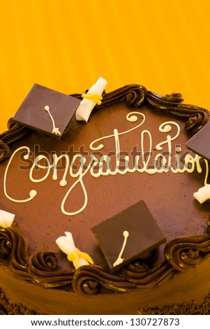 Gourmet chocolate cake decorated for graduation party.