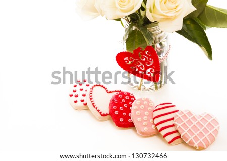 Gourmet cookies with bouquet of white roses.