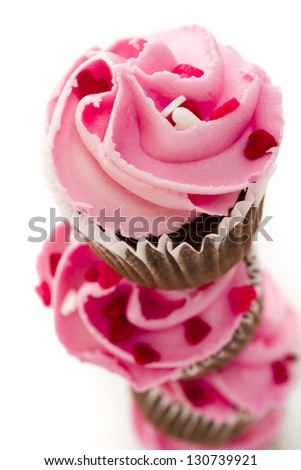 Stack of pink cupcakes on white background.