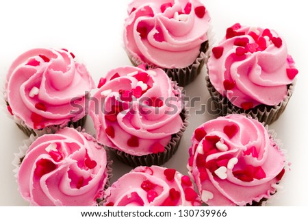 Pink Valentine's day cupcakes on white background.