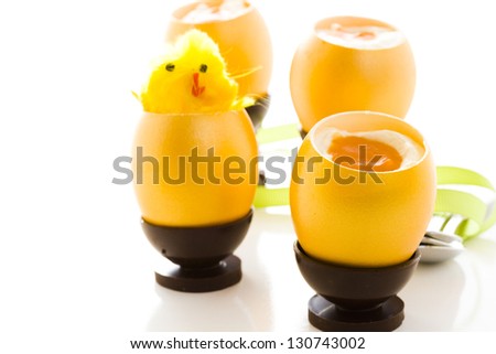 White chocolate passion fruit Easter egg in chocolate egg cup.