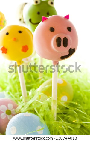 Dark chocolate Easter cake pops decorates with faces of different animals.